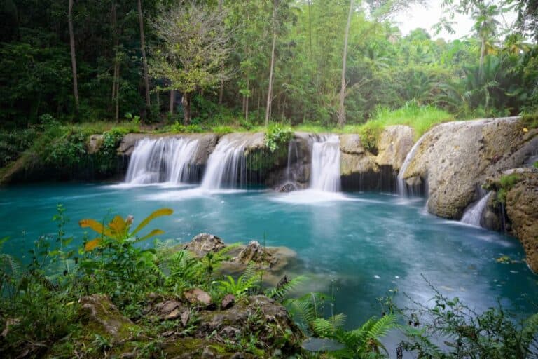 A peaceful waterfall surrounded by lush greenery, one of the hidden Everyday Spots in The Philippines.