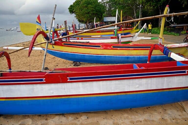 Colorful traditional fishing boats lined up on a sandy shore, reflecting Uncharted Filipino Traditions still practiced in coastal villages.