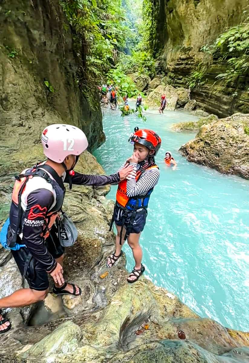 Kristine getting ready to be pushed on the water by the tour guide.