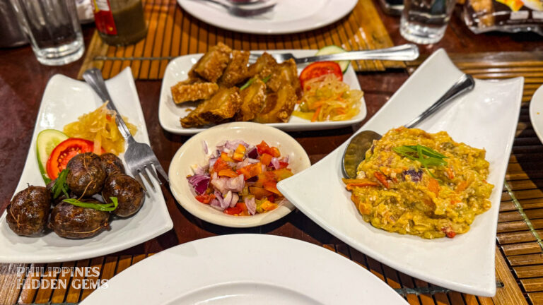 Plates of Filipino food in Vigan on a table.