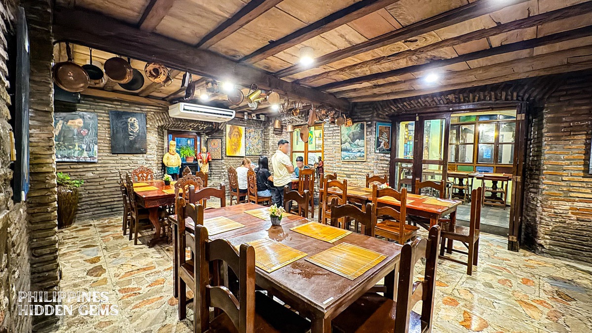 An old, rustic restaurant with wooden tables and chairs.