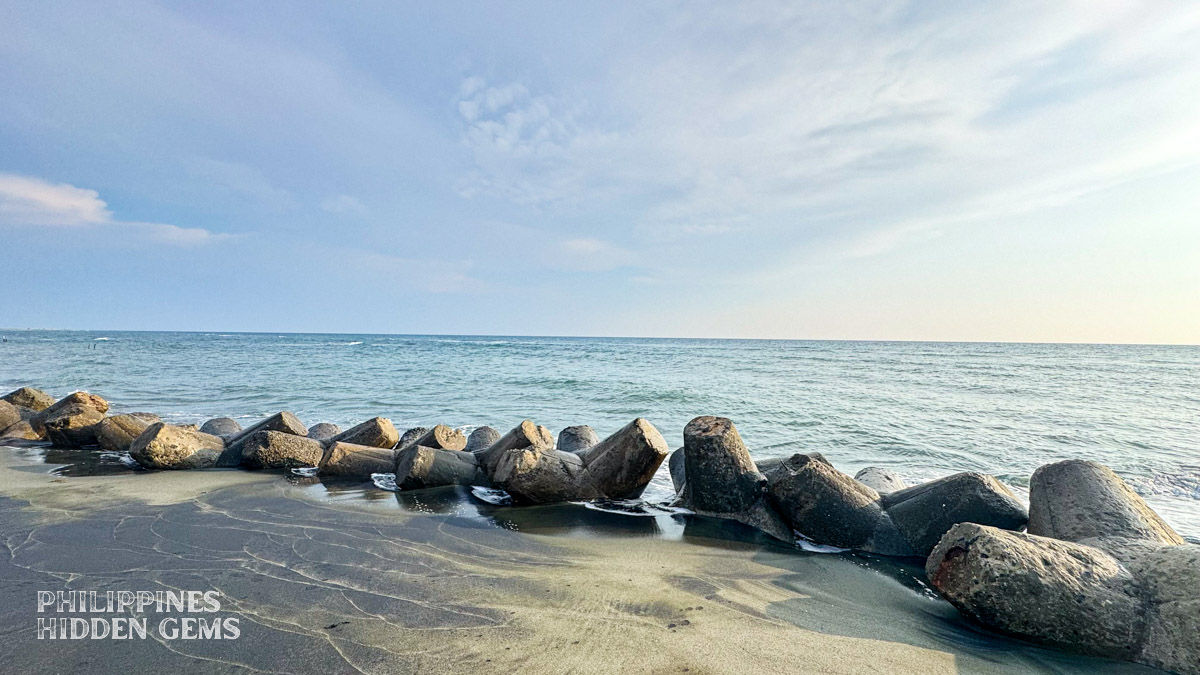 Beaches in Vigan with dark sand and jackstone-shaped concrete breakwaters.