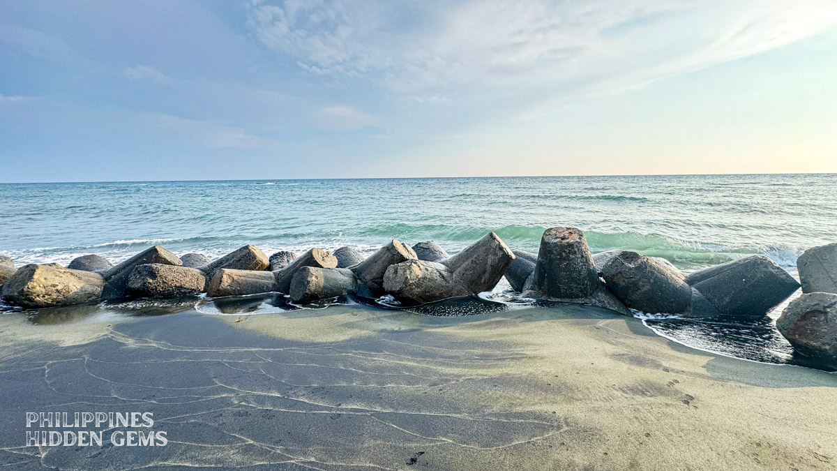 Jackstone-shaped concrete breakwaters at a black-sand beach in Vigan, Ilocos Sur, Philippines.