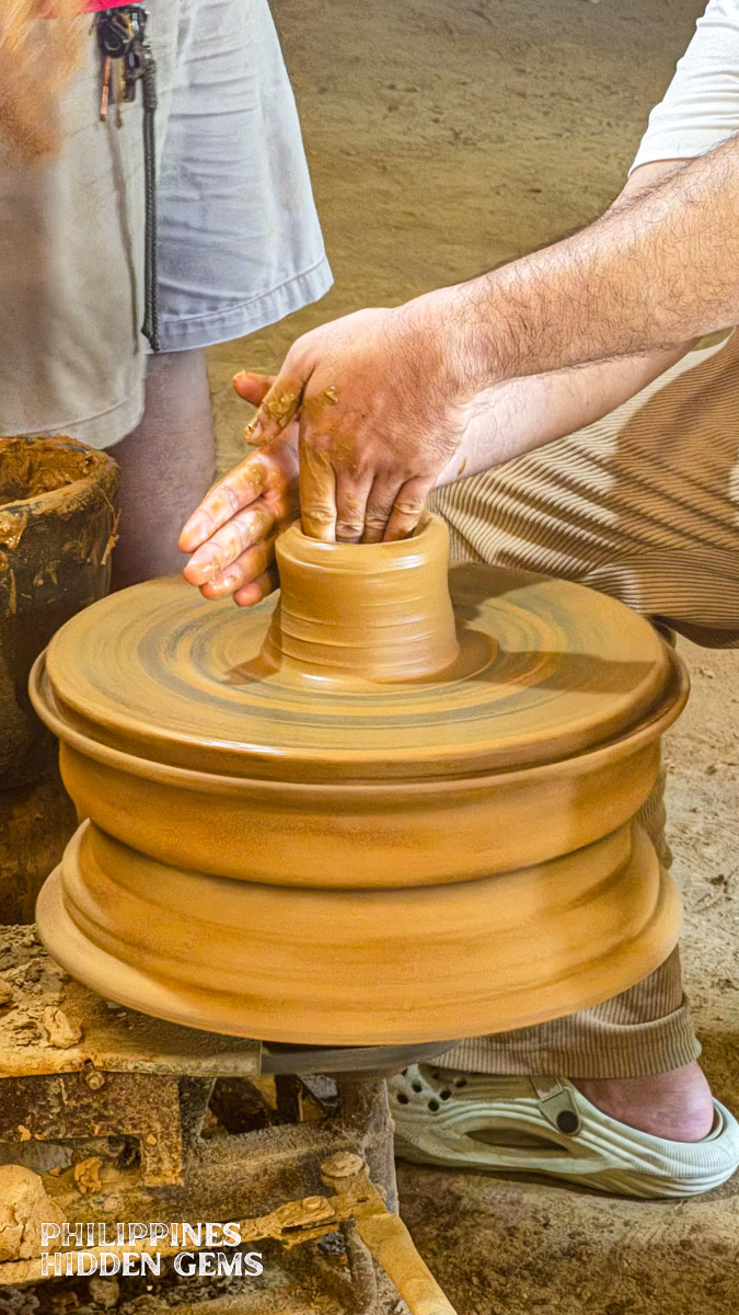 Electric pottery wheel being used to make a pottery piece.