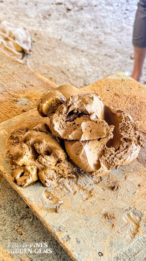 Pottery clay on wood.