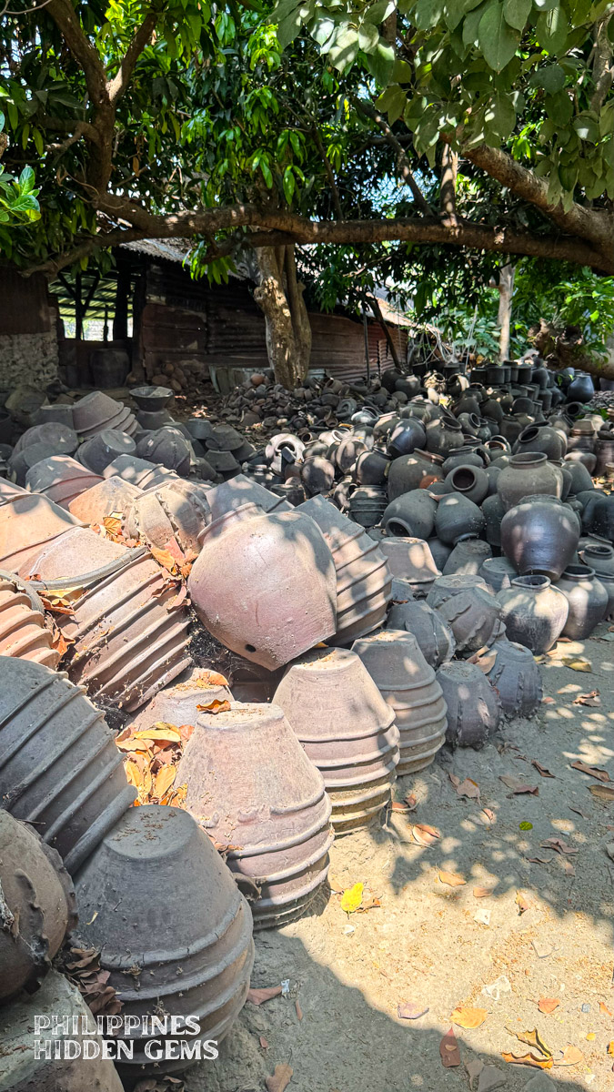 A pile of pottery jars displayed outdoors.