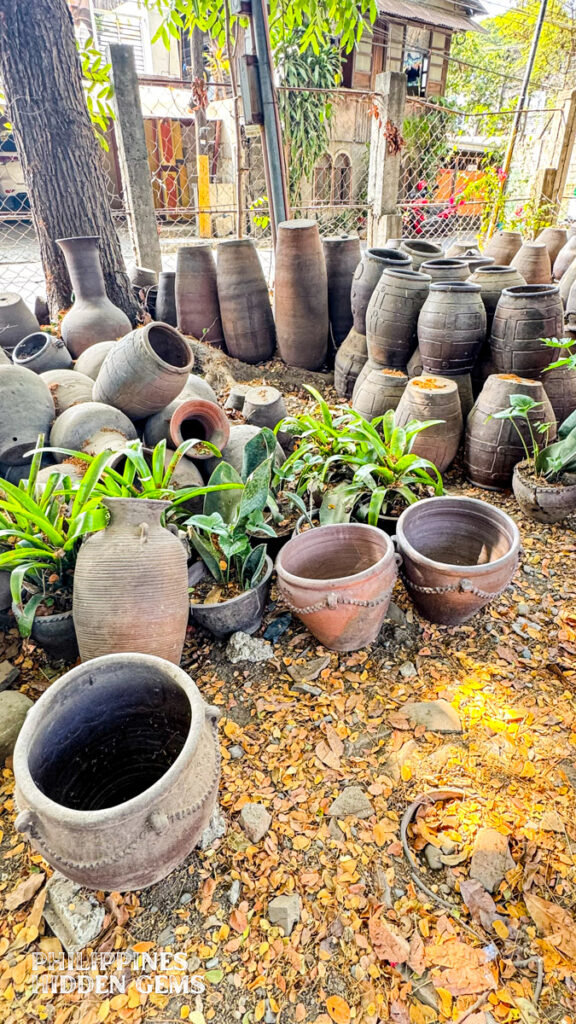 Large pieces of pottery vases at an outdoor garden.
