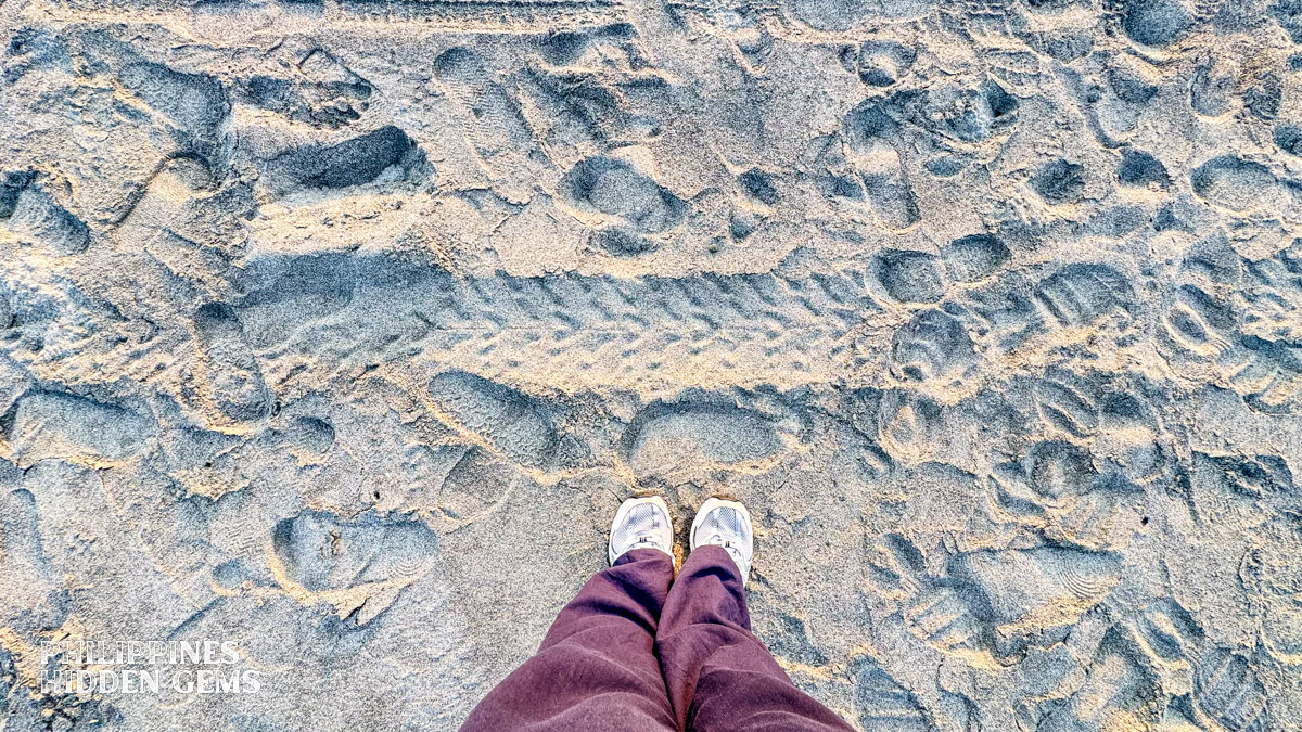 Gray sand at the beach.